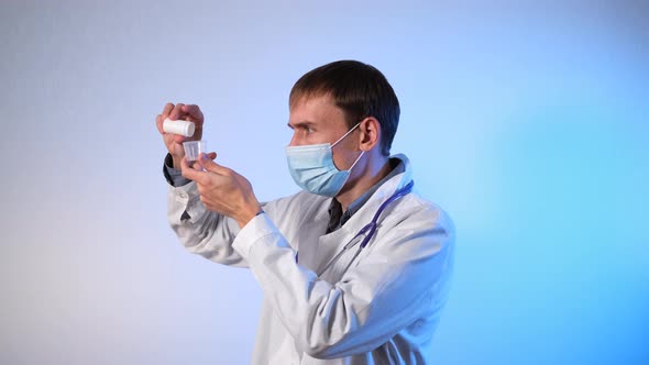 Male Doctor Pouring Medicines From Pill Bottle