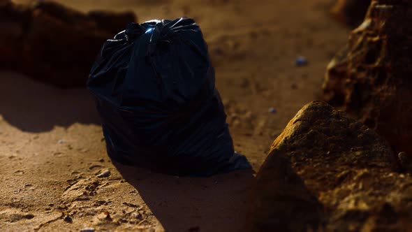 Black Plastic Garbage Bags Full of Trash on the Beach