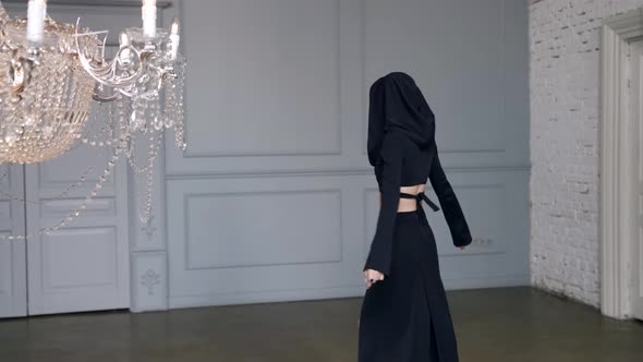 Mysterious Woman in Black Gown is Walking in White Room Emotional Lady