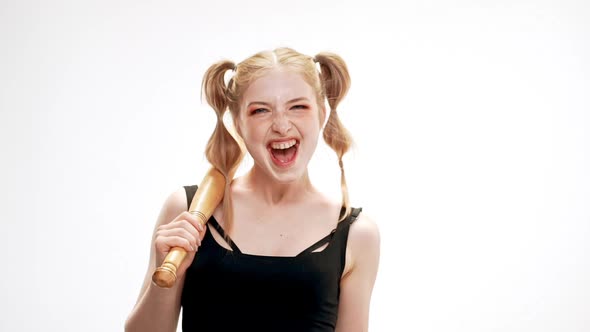 Young Beautiful Girl Laughing Holding Bat Over White Background