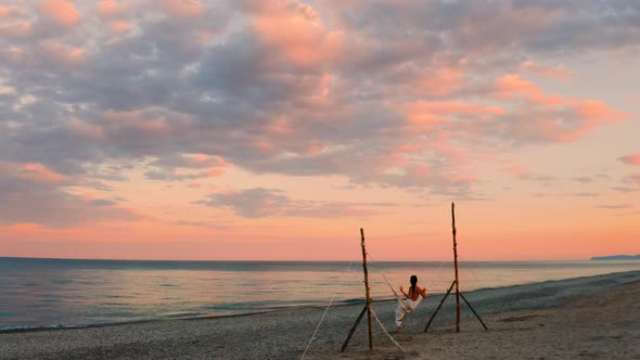 Girl on the Swing by the Calm Ocean