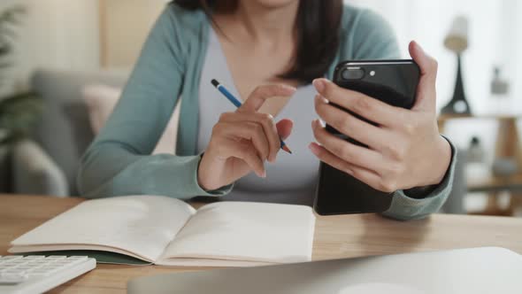 Asian Freelance Businesswoman making a video call conference on smartphone