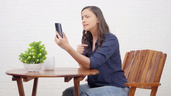 Angry Indian girl talking to someone on a video call