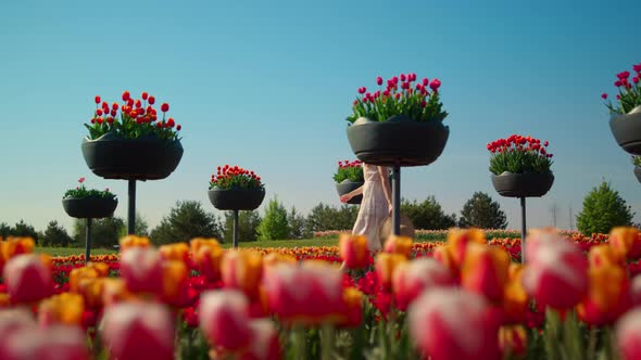 Unknown Female Person Moving Fast in Beautiful Blossomed Garden in Slow Motion