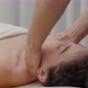 Female therapist massages clavicle and chest of young woman. Relaxing massage. Therapeutic massage. - VideoHive Item for Sale