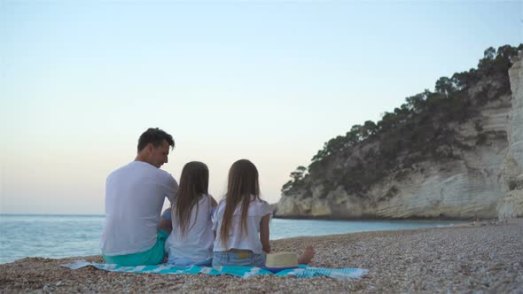Father and Two Daughters on the Beach
