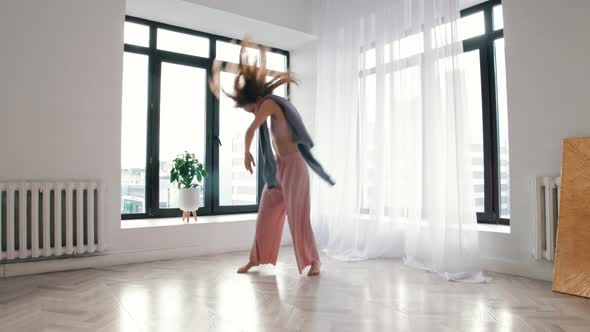 Street Dancing  a Young Woman Dances Plastically in a White Room