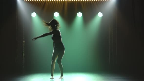 A Modern Dancer in Black Lingerie Performs Plastic Beautiful Dramatic Dances in a Dark Studio with