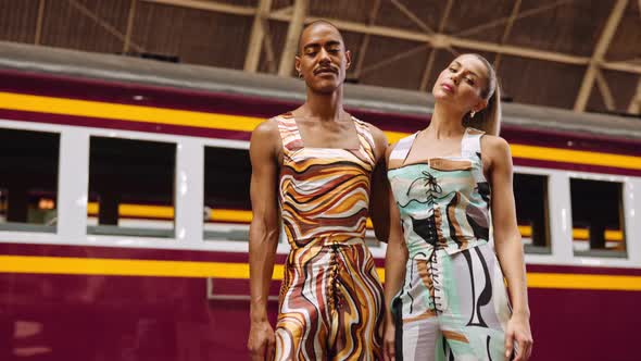 Fashion Models Posing In Patterned Clothing In Train Station