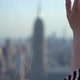Girl on Rooftop Looks Over New York City Panoramic View at Manhattan at Sunset - VideoHive Item for Sale