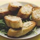 Slices of Garlic Cheese Bread Served on a Plate Arugula Leaves - VideoHive Item for Sale