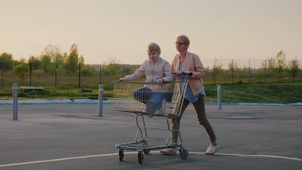 Mom Rolls Her Daughter in a Shopping Basket