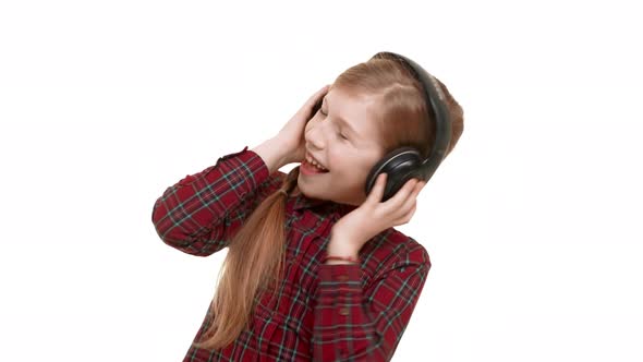 Lovely Active Elementaryschool Aged Caucasian Girl Listening Music Through Headphones Dancing