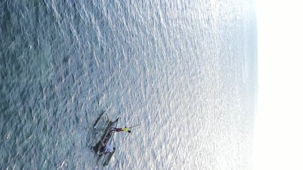 Vertical Video Boats in the Ocean Near the Coast of Zanzibar Tanzania Aerial View