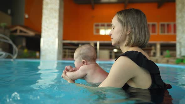 Mother Teaches Her Baby to Swim in a Closed Public Pool