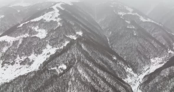 Aerial view of beautiful snowy mountains in Pasanauri, Georgia