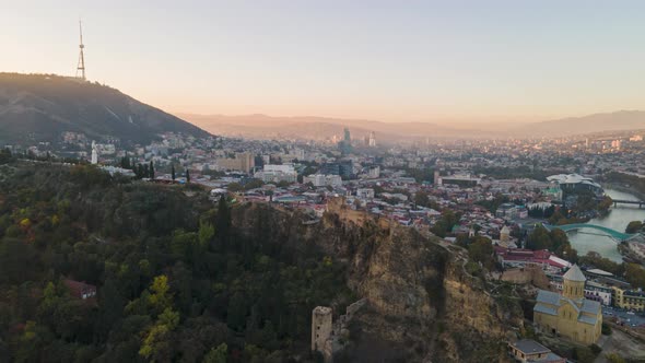 Aerial hyperlapse of beautiful cityscape of Tbilisi at sunset, Georgia