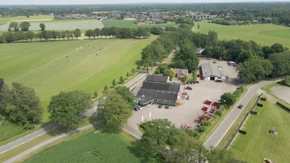 Aerial orbit of agricultural company with heavy machinery on lot