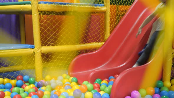 Children's Playroom. Children Play in a Dry Basin Filled with Plastic Colored Balls