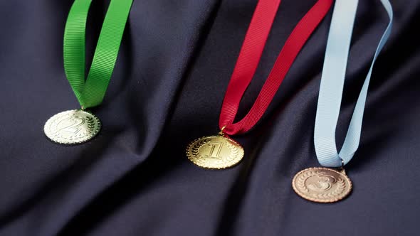 Gold Silver and Bronze Medals with Ribbons on Black Background Closeup