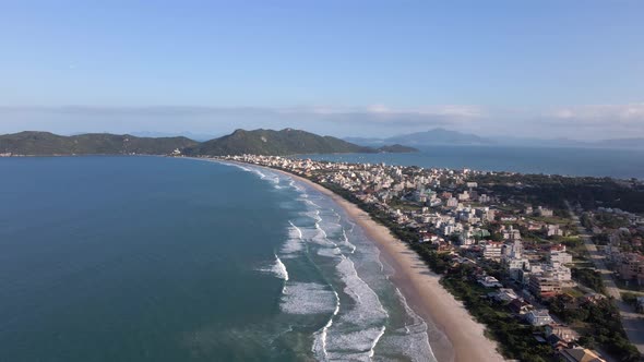 High Aerial View of Sunny Zimbros Beach in Brazil. Forward Flight.