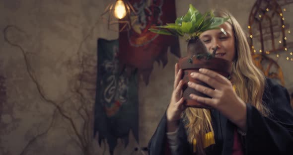 Student of the Wizard School is Holding a Flower Pot with Mandragora Root