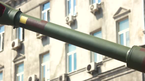 Tank Gun Barrel on Buildings Background