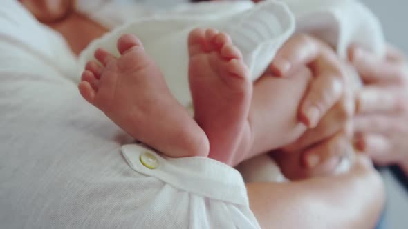 Close-up of Caucasian mother holding her newborn baby in the ward at hospital