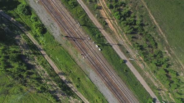 Electrified Railway Track. The Camera Is Gaining Altitude While Rotating