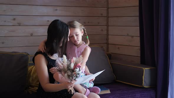 Happy Woman Embracing Daughter on Mothers Day