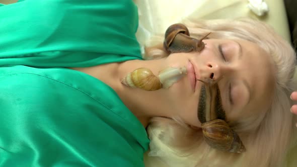 Cosmetologist Putting Snails on Female Face