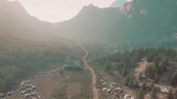 Old Wooden Village on the Rocky Mountain Background