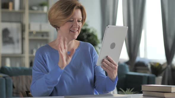 Online Video Chat By Old Senior Woman on Tablet