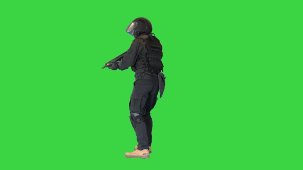 Police Special Forces Officer Holding Position on a Green Screen Chroma Key