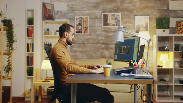 Side View of Game Developer Working From Home Office