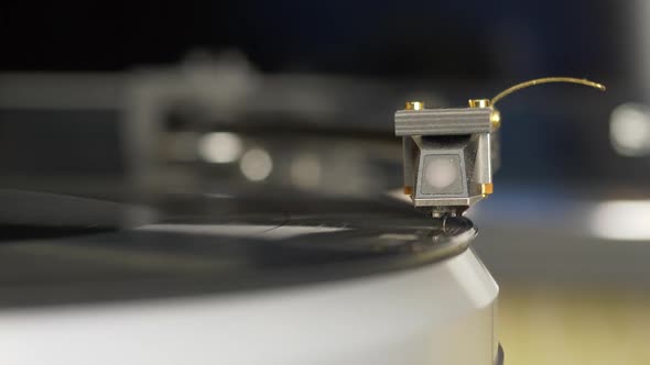 Vinyl Record Player. Needle Headshell of Turntable Slow Down on Vinyl Record Rotating