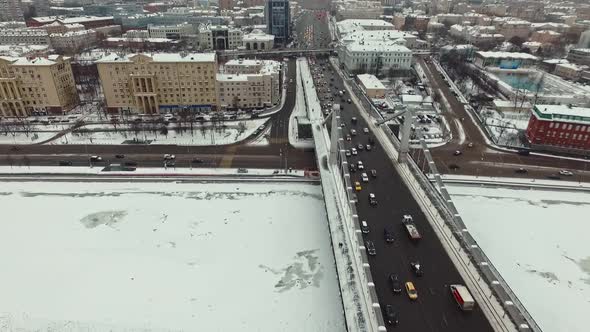 Cars Pass Over the Cable-stayed Bridge Over the River in Winter