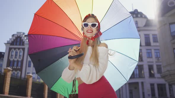 Portrait Young Fun Woman Looking at the Camera Holding Multicolored Umbrella Standing on the Street