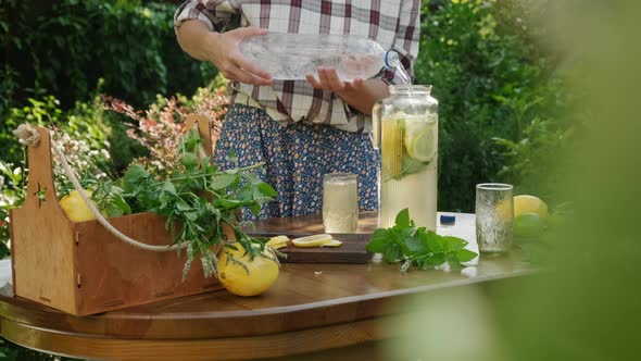 Woman Making Homemade Summer Lemonade Drink