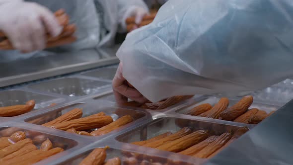 Workers of the Meat Processing Factory Place Readymade Sausages in Plastic Packages