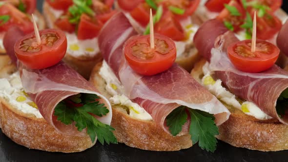 stylish snack bruschetta with italian prosciutto or spanish jamon top view