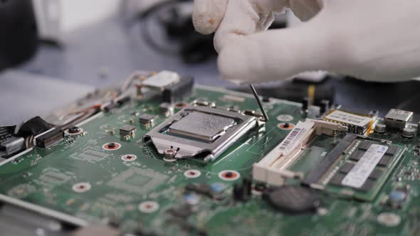 Hands of the Technician Repairing a Computer, Technician Who Changes the Computer's Processor, Close