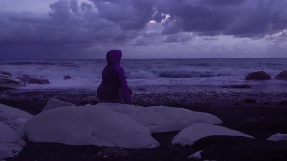 Girl on the Seashore Against the Backdrop of Storm Waves