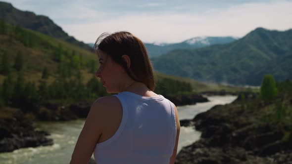 Lady Looks at Curved River and Old Mountains in Valley