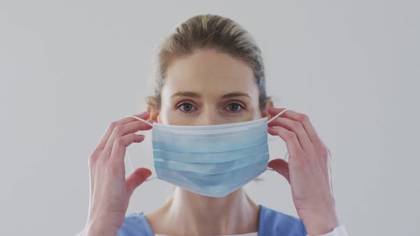 Female health worker wearing face mask at home