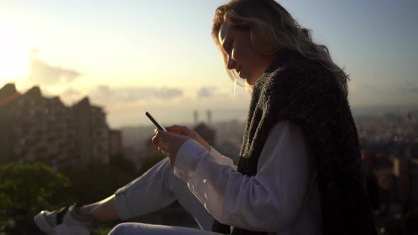 Woman writing text message on smartphone