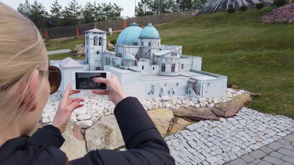 Woman Takes a Photo Near a Miniature Building in the Arabian Oriental Style. Park of Miniatures.