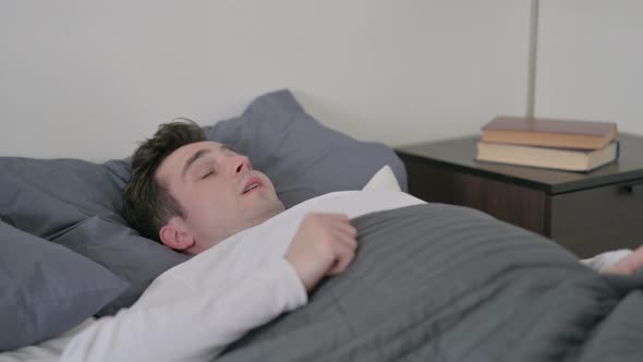 Man Waking Up From Sleep in Bed