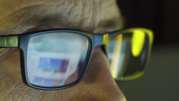 Closeup of the Focused Eyes of a Businessman Wearing Computer Glasses