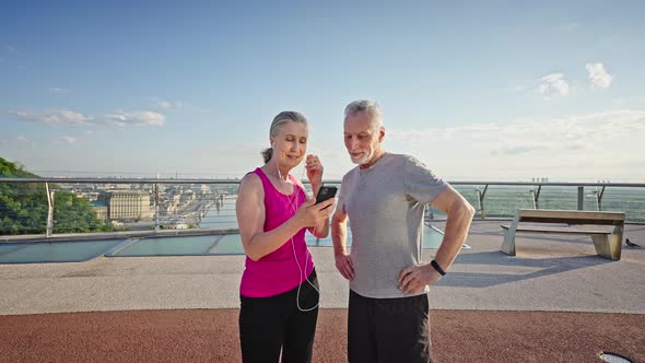 Aged Woman Shares Favorite Music with Friend After Training